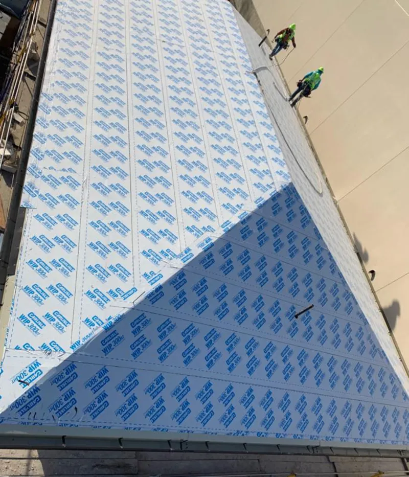 Professional roofers installing underlayment on a metal roof in La Joya